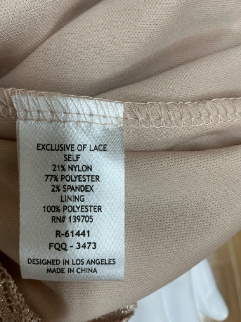 Fabric content tag of Emerald Sundae tan lace dress, listing nylon, polyester, and spandex blend with 100% polyester lining.