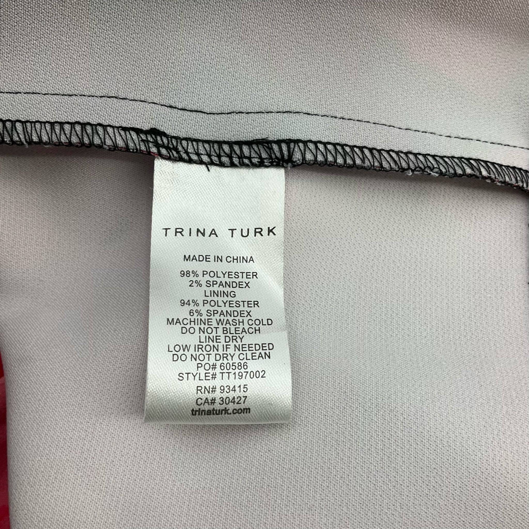 Fabric content and care label of Trina Turk Scoop Neck Knee Dress Size 10, detailing polyester-spandex blend, from Margaret’s Fine Consignments.