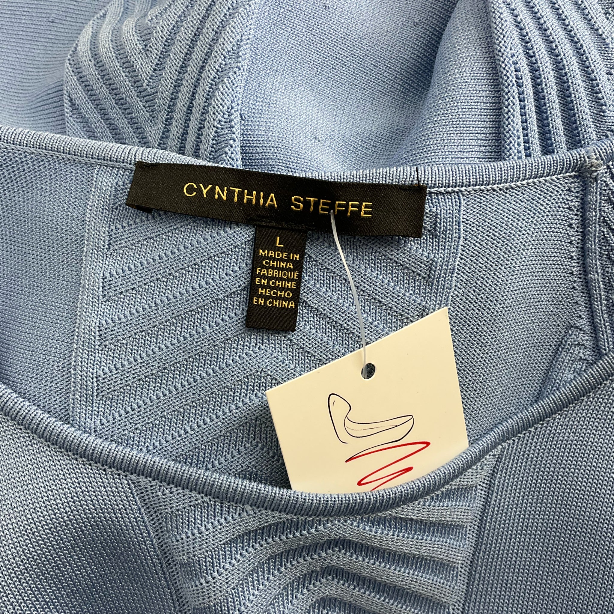 Close-up of Cynthia Steffe brand label on Blue Textured Dress - Size Large, confirming authenticity and pre-owned condition.
