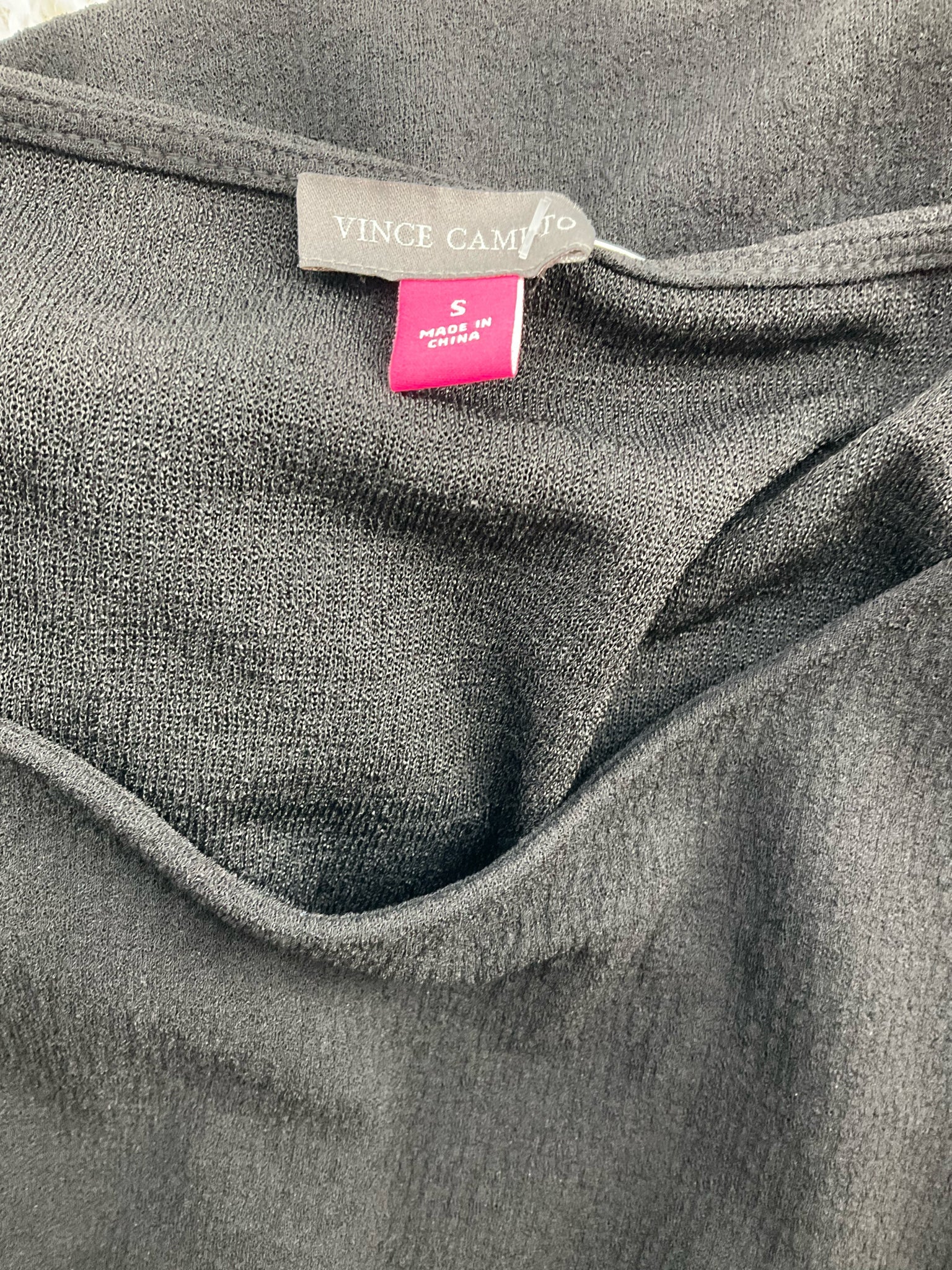 Vince Camuto black pre-owned ladies top featuring boat neck, twist front, and drop shoulder design in size small.