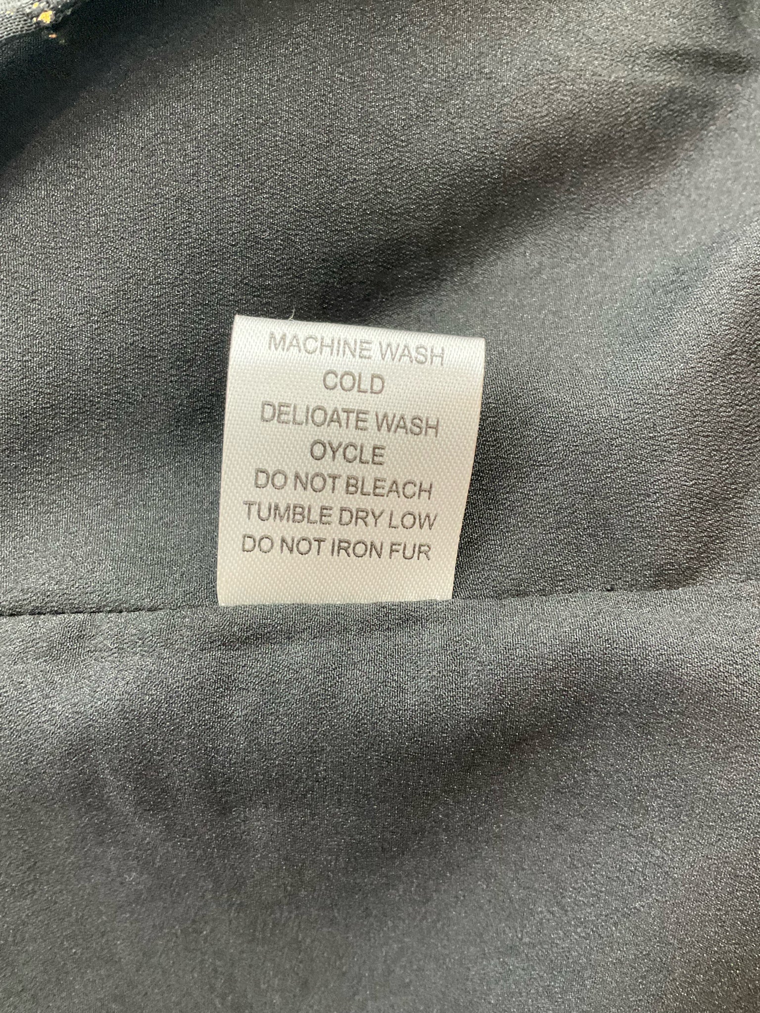 Pre-owned Joy Joy ladies top in black with gold dots, size XS, featuring a stylish design and a relaxed fit.