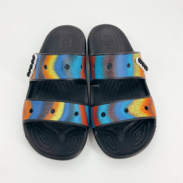 Top view of Crocs Rainbow Print Pre-Owned Ladies Sandals - Size 8 showing colorful solarized graphic straps and textured footbed for casual comfort.