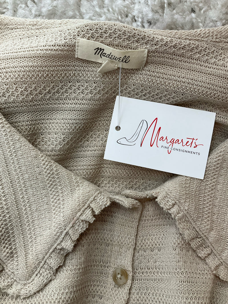 Close-up of Madewell label and Margaret’s Fine Consignments tag on tan scallop-trimmed Peter Pan collar cardigan. Pre-owned, soft knit texture.