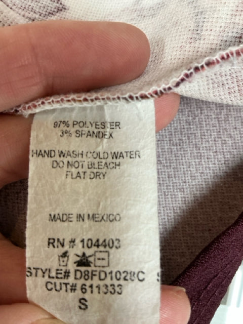 Close-up of care label on Blu Pepper Maroon Floral Pre-Owned Ladies Dress - Size Small, showing fabric composition and washing instructions.