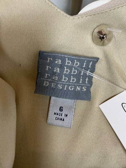 Brand tag of Rabbit Rabbit Rabbit Designs on beige pre-owned ladies dress, size 6, made in China, ideal for cocktail or wedding guest attire.