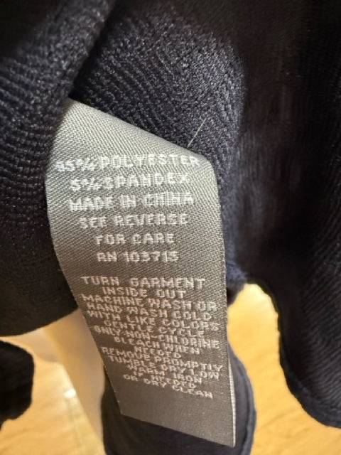 Fabric care label of Sharagano Crew Neck Dress Size 10, detailing polyester and spandex blend, featured at Margaret’s Fine Consignments.