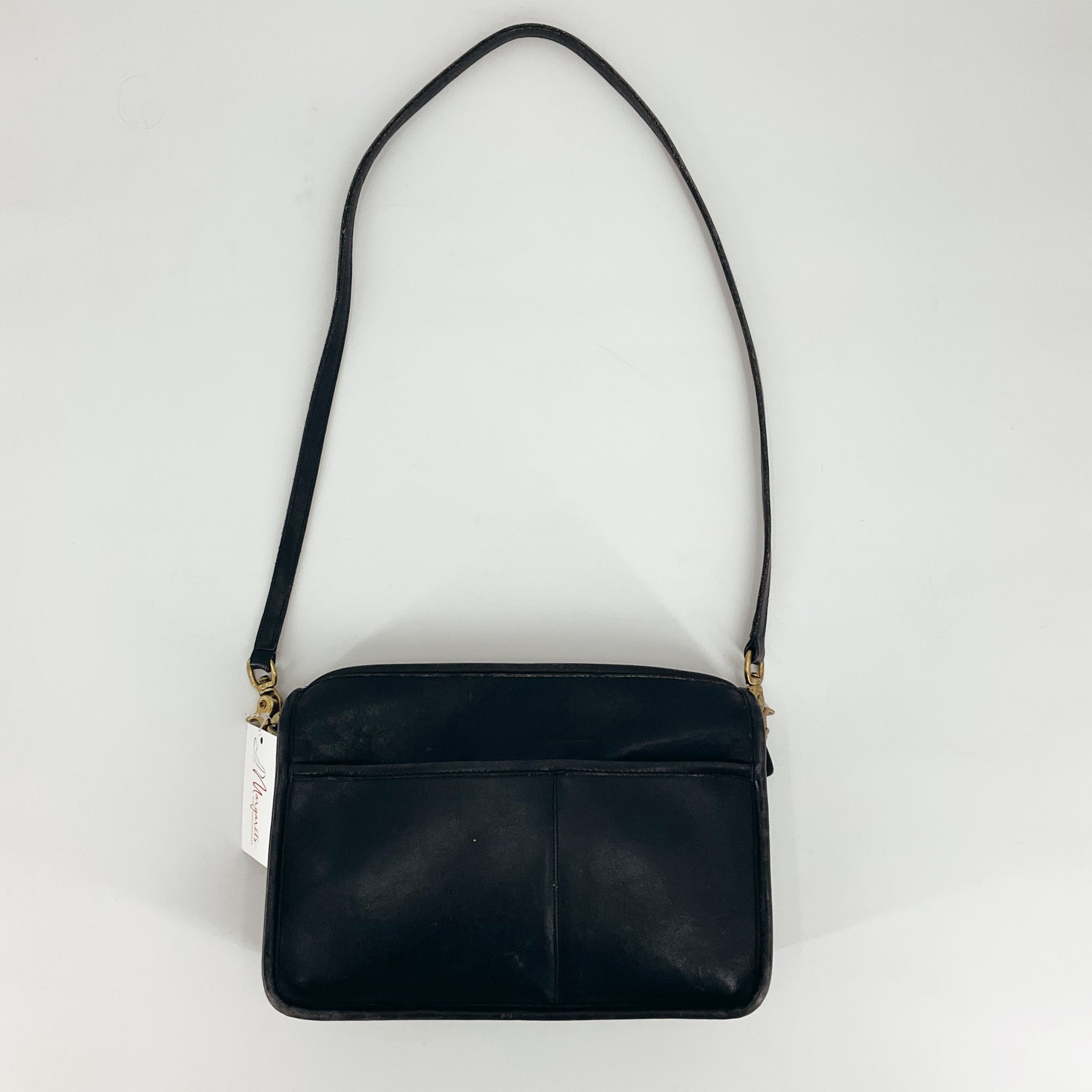 Coach Black Solid Purse with shoulder strap, gently used and pre-owned, available at Margaret’s Fine Consignments. Sleek leather design for everyday luxury.