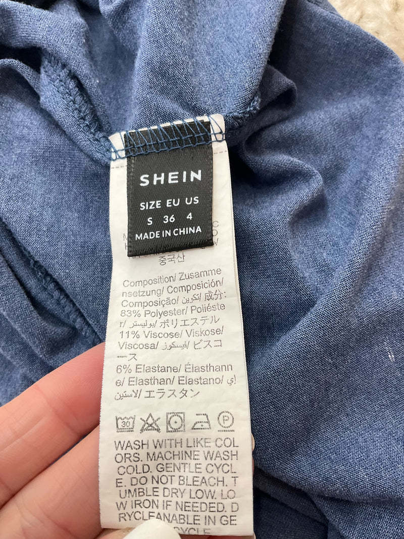 Close-up of Shein tank top care label showing size small, fabric composition, and washing instructions.