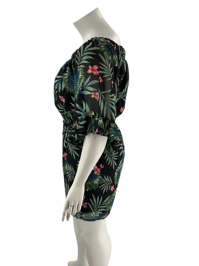 Side profile of Indulge Leaf Print Pre-Owned Romper - Size 1X highlighting off-shoulder design and relaxed silhouette with leafy print.