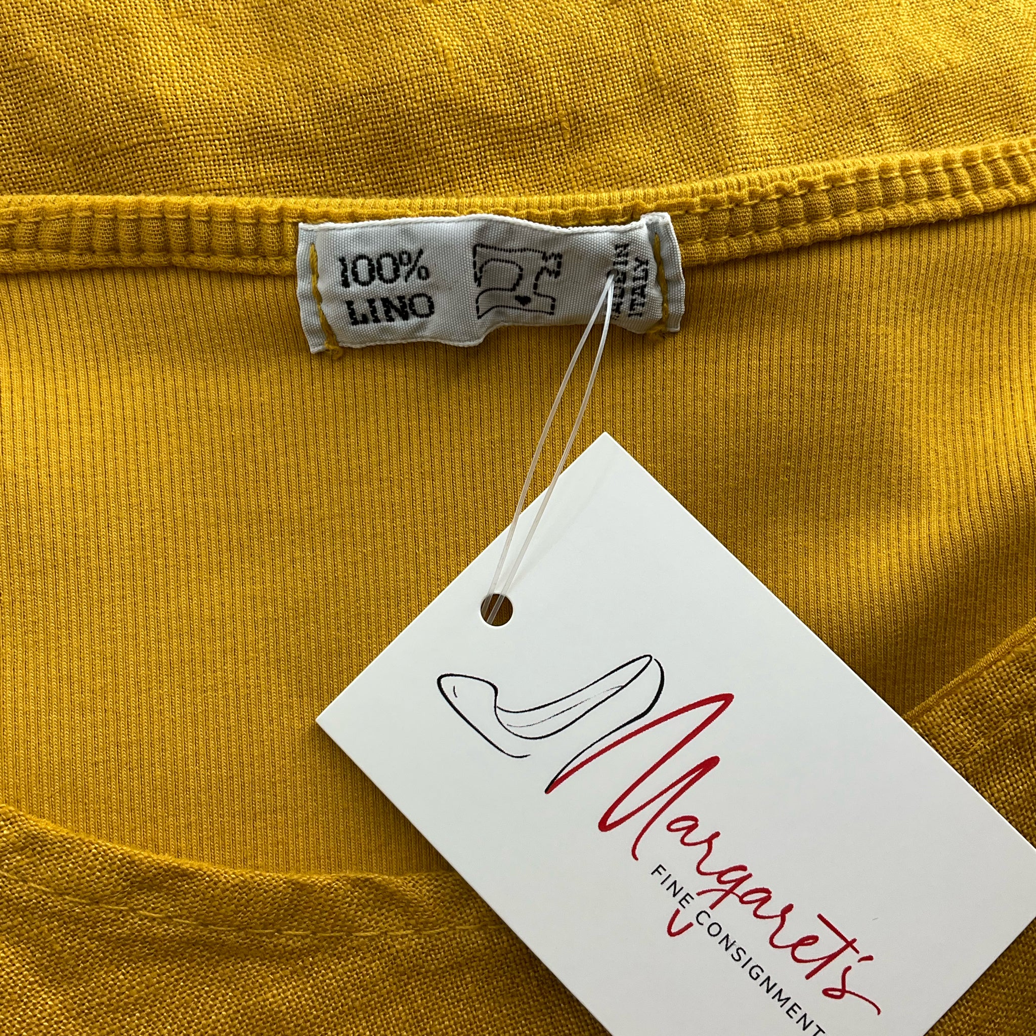 Close-up of 100% Lino label on Mustard Dress - Size Large, confirming authentic linen material from Margaret's Fine Consignments.