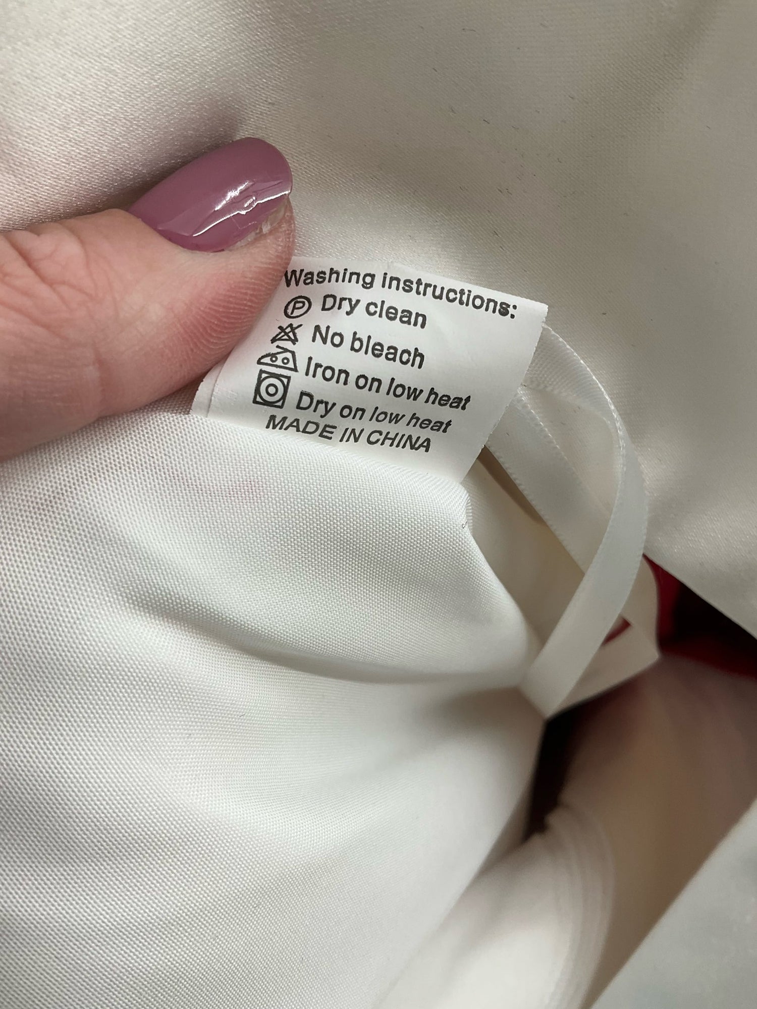 White and red embroidered No Brand midi dress, high-low fit and flare style, size 12, elegantly displayed on a mannequin.