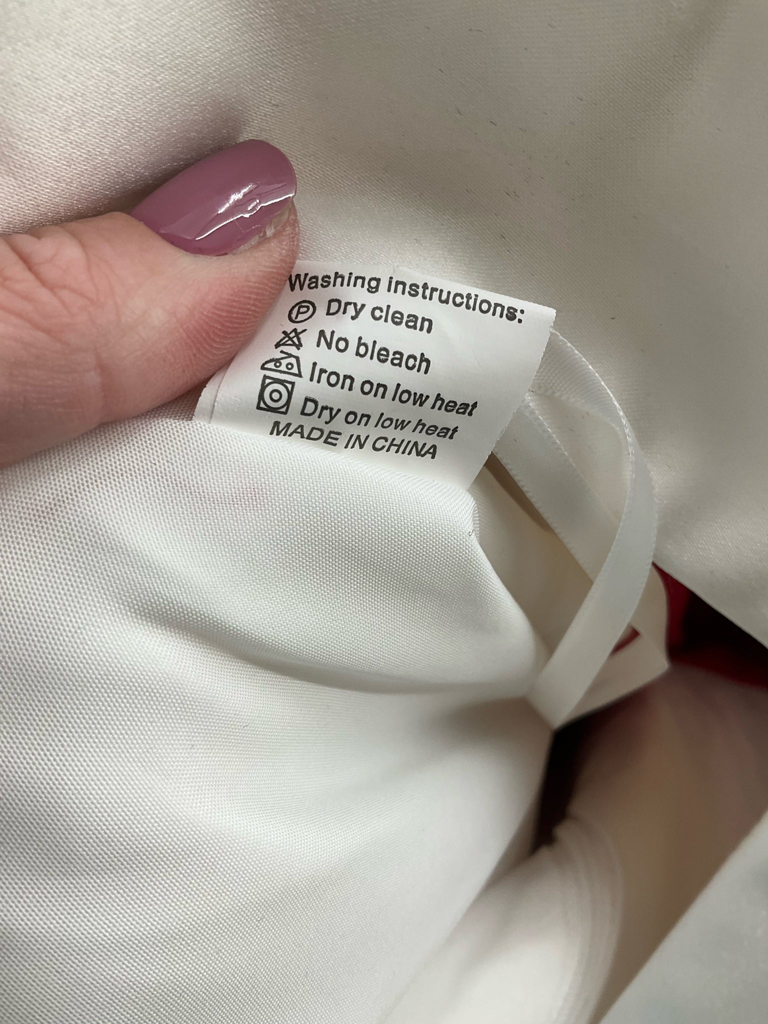 White and red embroidered No Brand midi dress, high-low fit and flare style, size 12, elegantly displayed on a mannequin.