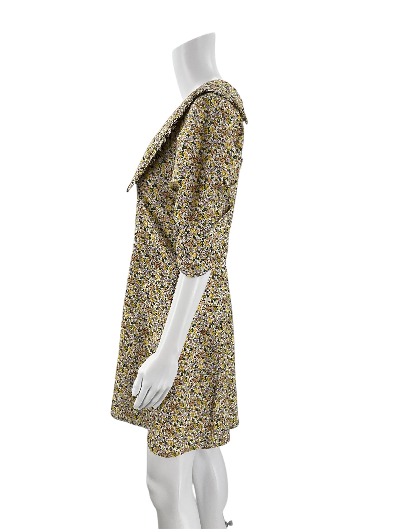 Side profile of Anthropologie Cream/Yellow/Orange Floral Dress - Size 10 showing structured puff sleeves and flattering A-line silhouette.
