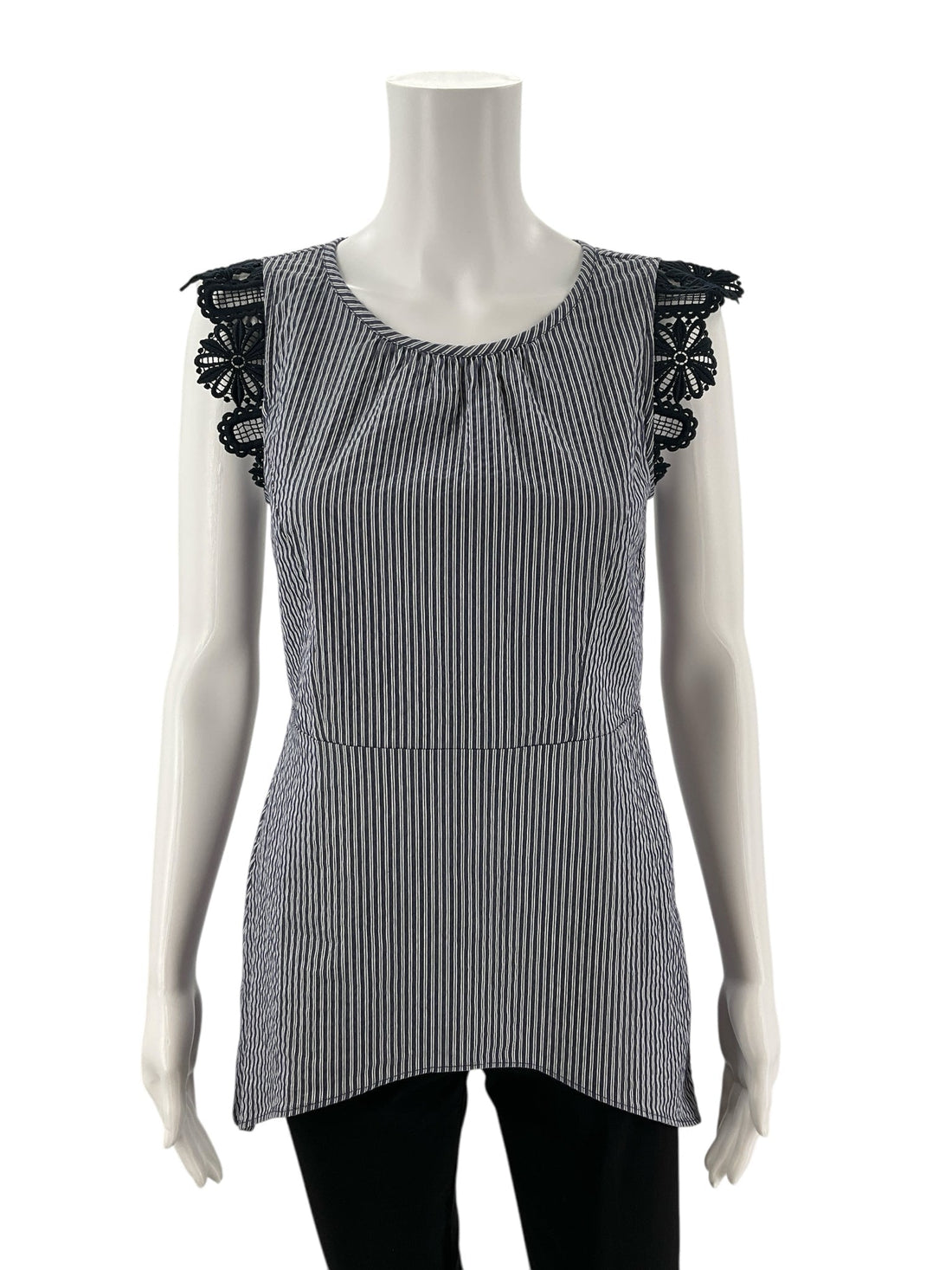 Front view of Cabi Tapestry Top XS on mannequin, showcasing vertical blue and white stripes and black lace cap sleeves in a sleeveless shell design.