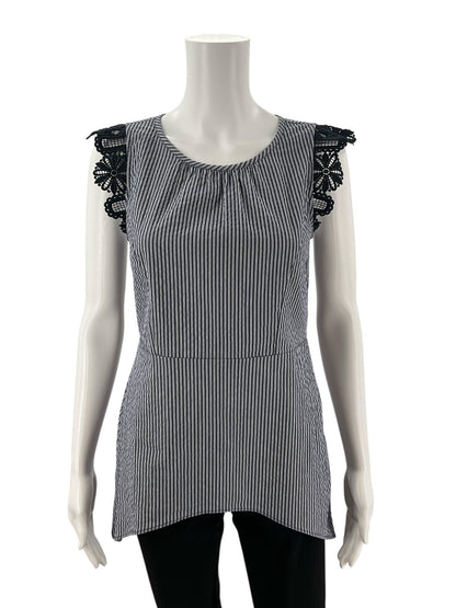 Front view of Cabi Tapestry Top XS on mannequin, showcasing vertical blue and white stripes and black lace cap sleeves in a sleeveless shell design.
