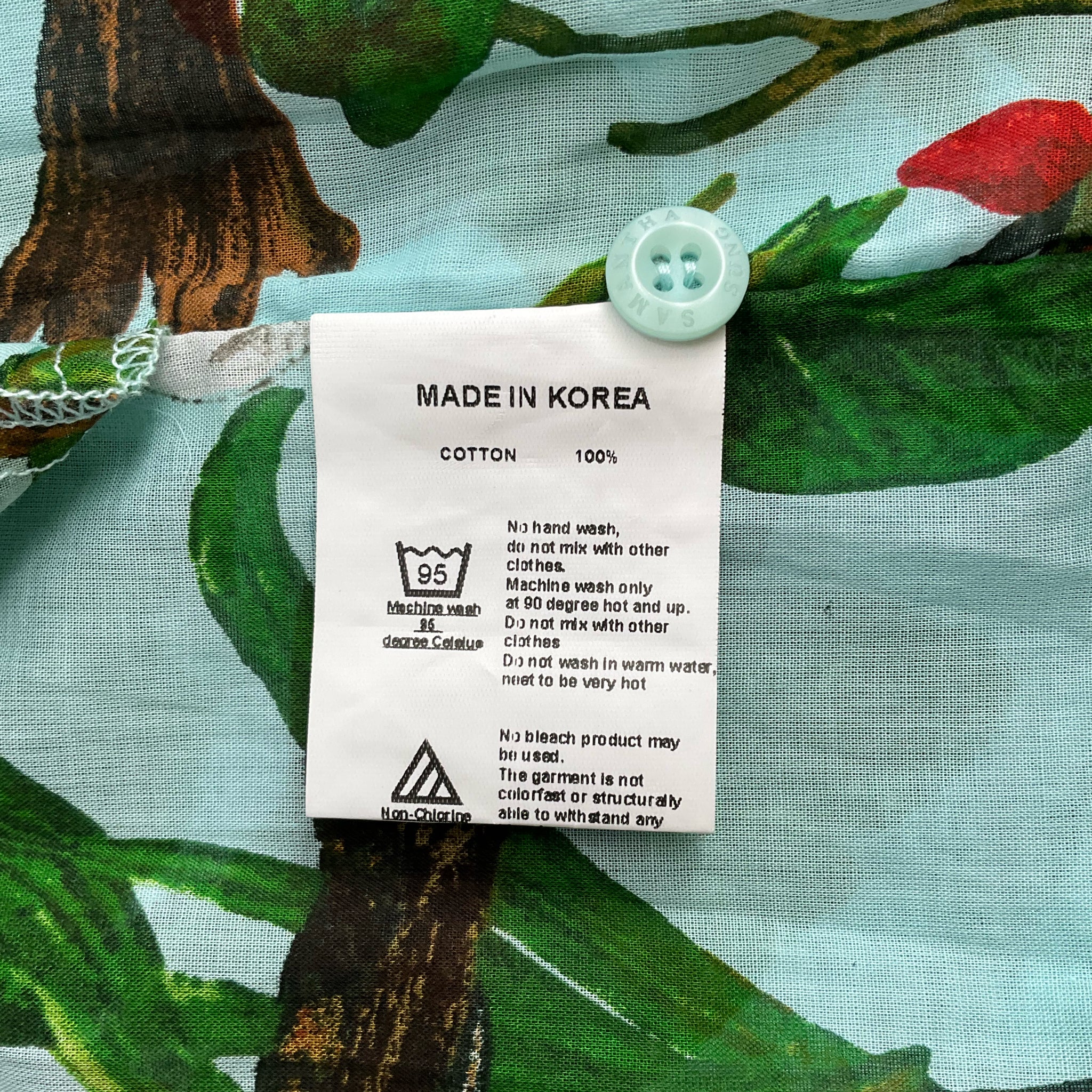 Fabric tag on Samantha Sung Aqua/Green Floral Maxi Dress Size 4 indicating 100% cotton material and made in Korea.