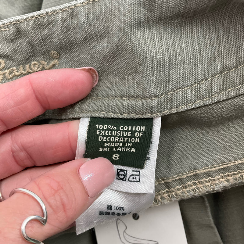 Size and material tag of Eddie Bauer Olive Shorts - Size 8, made from 100% cotton for breathable comfort.