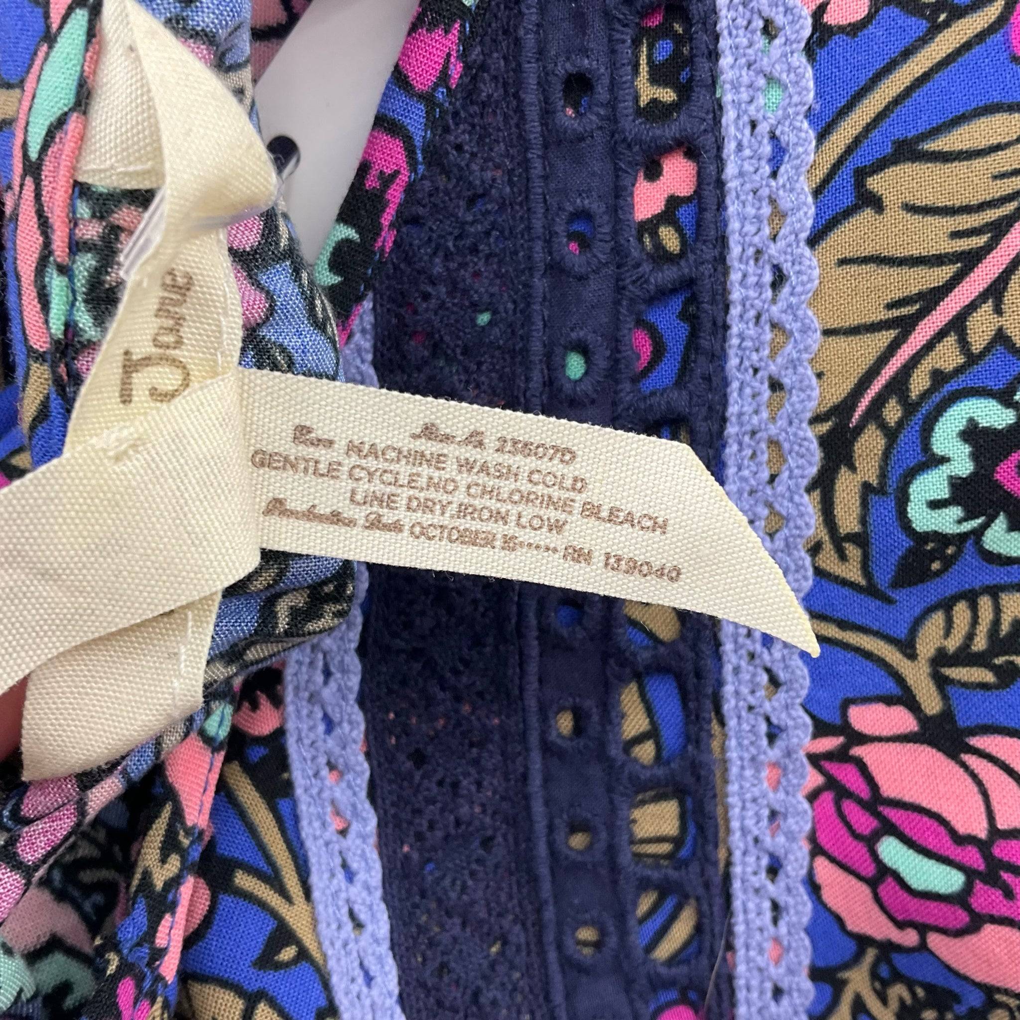 Fabric care label of Matilda Jane Dress Size Medium in blue/multi floral print, sold by Margaret’s Fine Consignments.