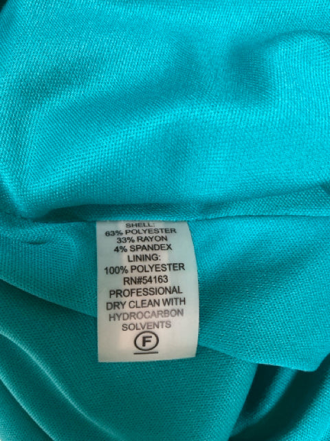 Close-up of fabric tag on Calvin Klein teal dress, detailing polyester-rayon-spandex blend and dry clean instructions.