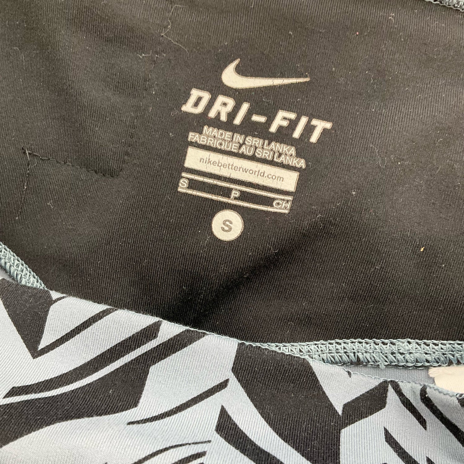 Nike blue and navy print pre-owned ladies activewear pants in size small displayed flat.