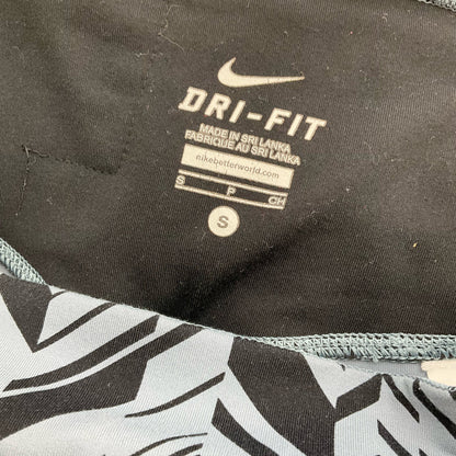 Nike blue and navy print pre-owned ladies activewear pants in size small displayed flat.