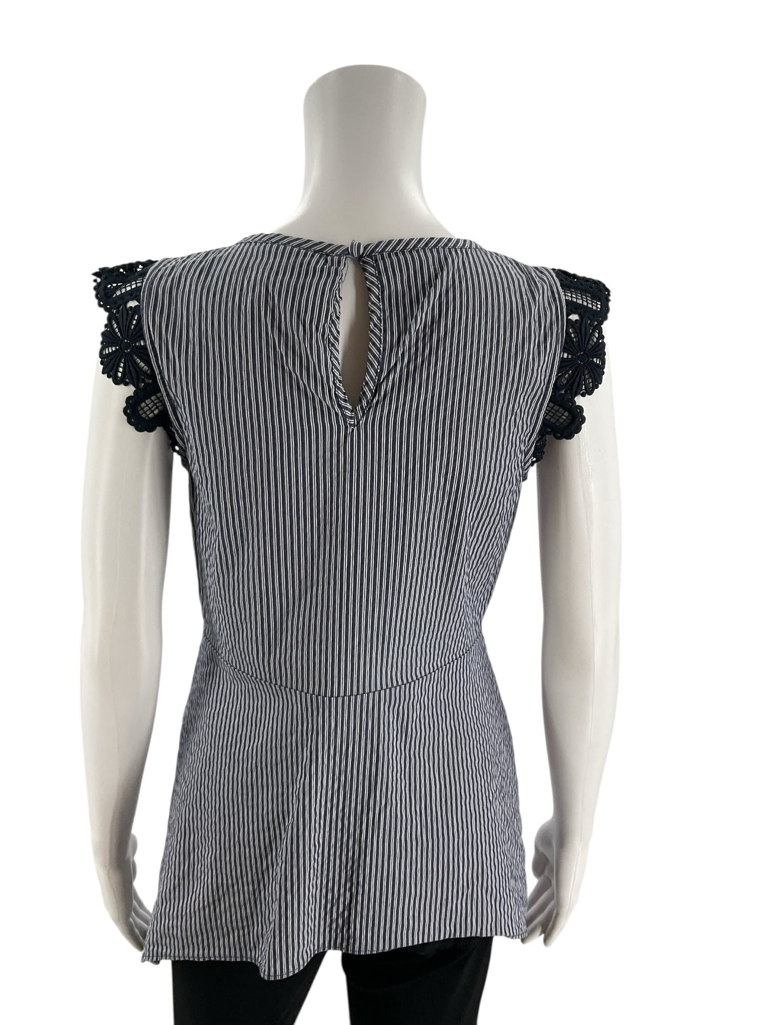 Back view of Cabi Tapestry Top XS on mannequin, highlighting the keyhole back closure and striped pattern with lace cap sleeves.