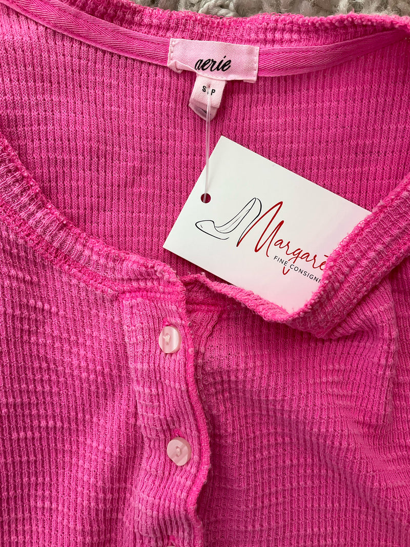Close-up of Aerie Pink Pre-Owned Ladies Top - Size Small neckline and buttons, showing brand tag and consignment label attached.
