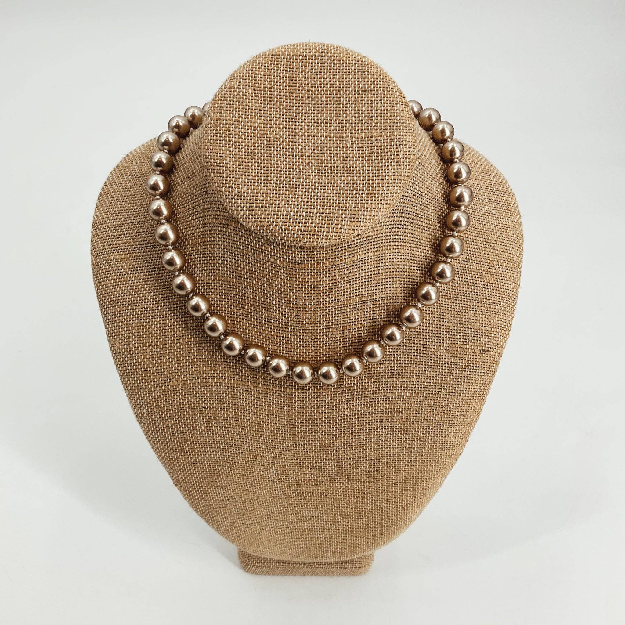 Ralph Lauren champagne pearls necklace featuring round vintage pearls on a display bust. Elegant statement jewelry for formal or evening wear.