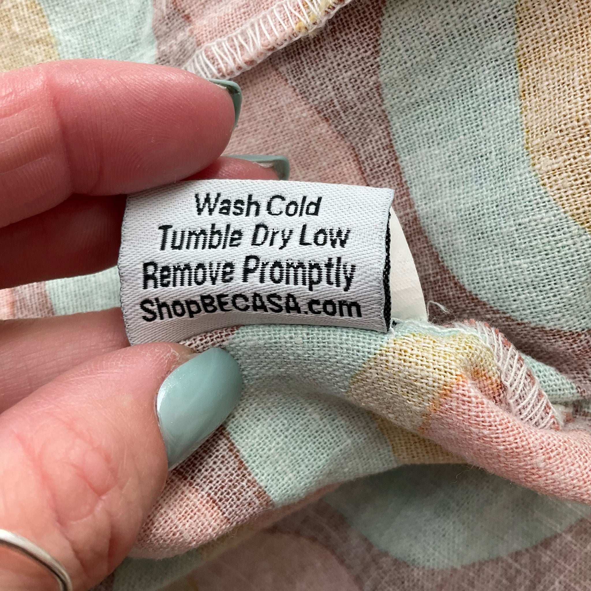 Care label for Becasa Rust/Multi Circles Print Dress - Size XS with washing instructions. Lightweight linen dress available pre-owned at Margaret’s.