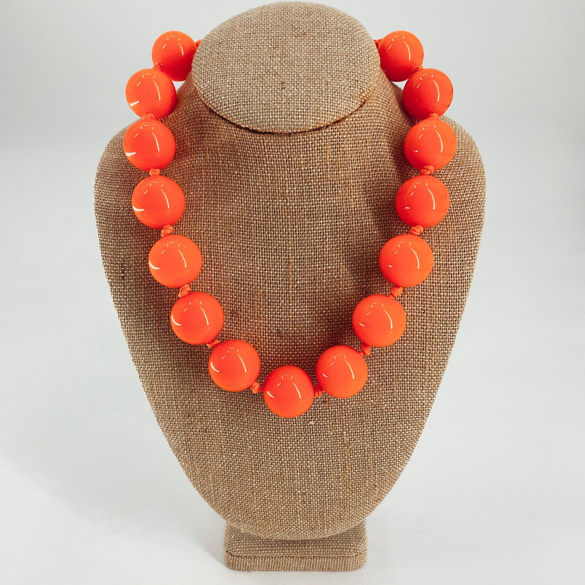 Orange beaded necklace featuring large glossy round beads, ideal for bold fashion statements in the necklace category.