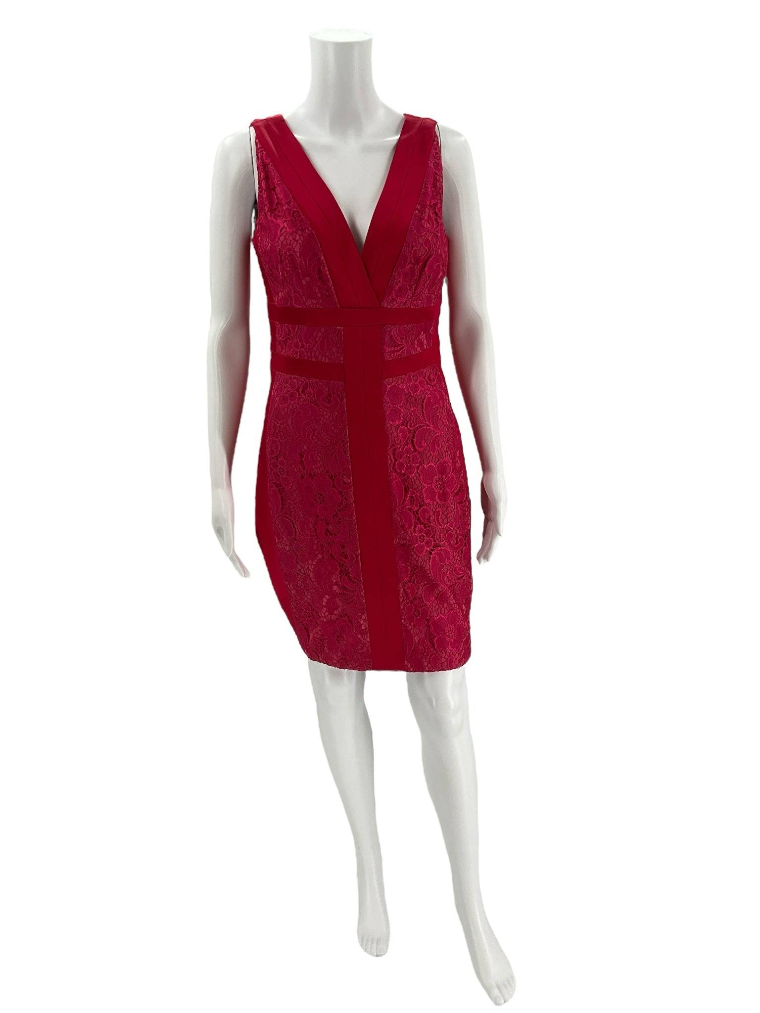 Front view of Jax V Neck Mini Dress Size 8 in pink lace on mannequin, featured at Margaret’s Fine Consignments. Romantic sleeveless cocktail dress.