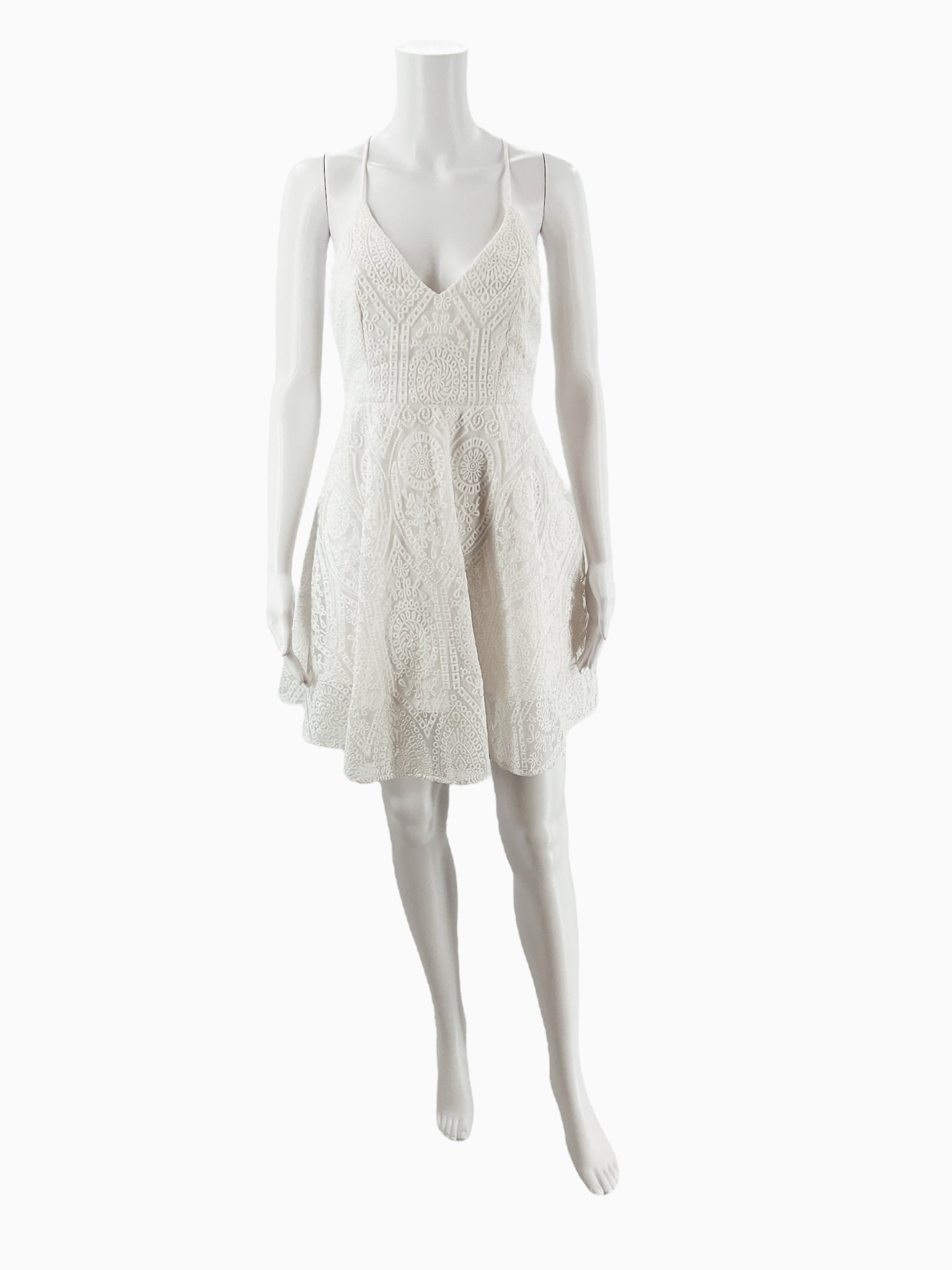 Front view of Illa Illa white textured lace mini skater dress on mannequin, featuring v-neckline and flared A-line silhouette, size medium.