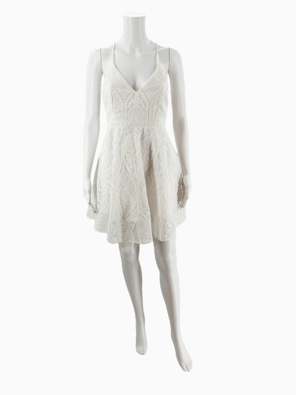Front view of Illa Illa white textured lace mini skater dress on mannequin, featuring v-neckline and flared A-line silhouette, size medium.