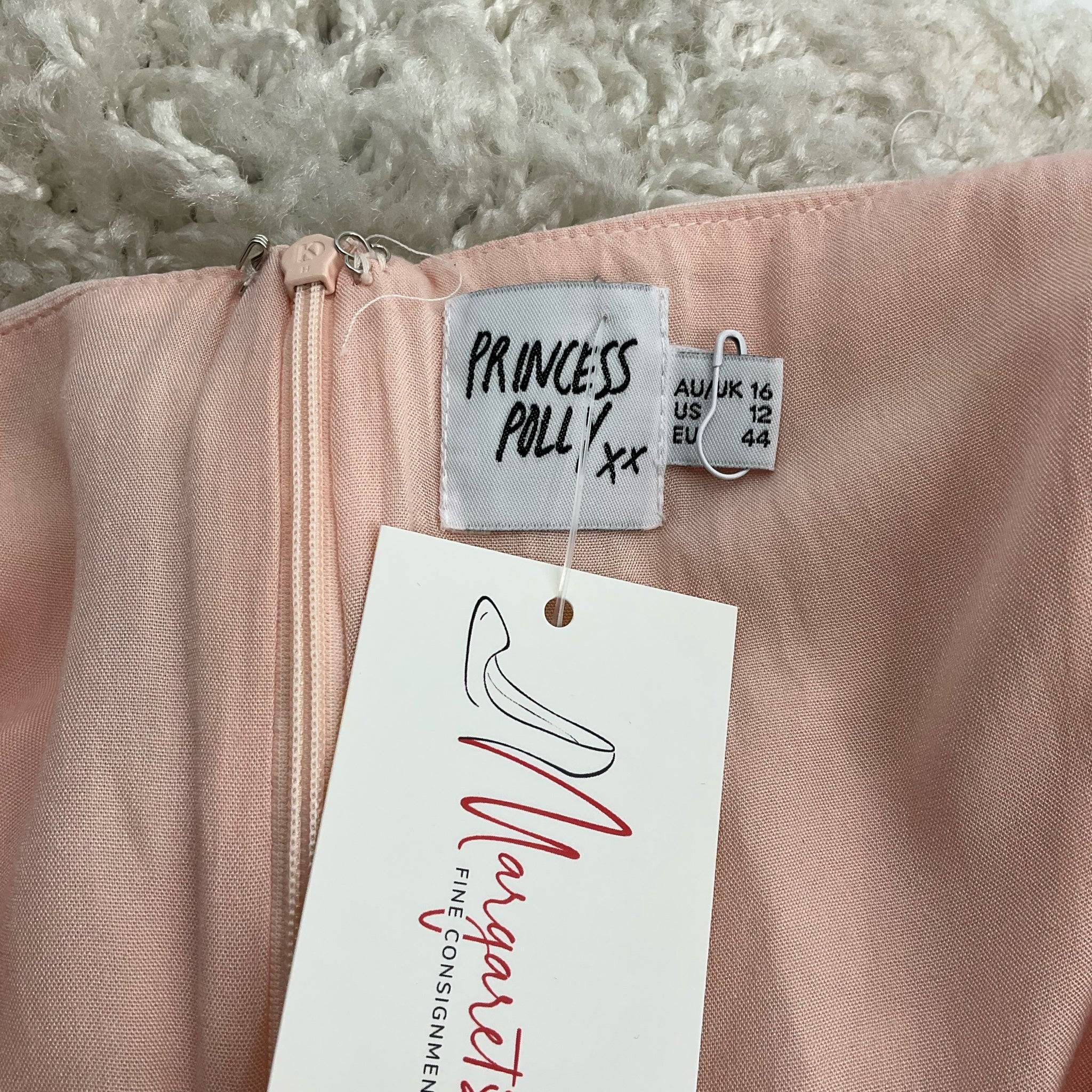 Close-up of Princess Polly dress label showing size 12 and Margaret’s Fine Consignments tag attached.