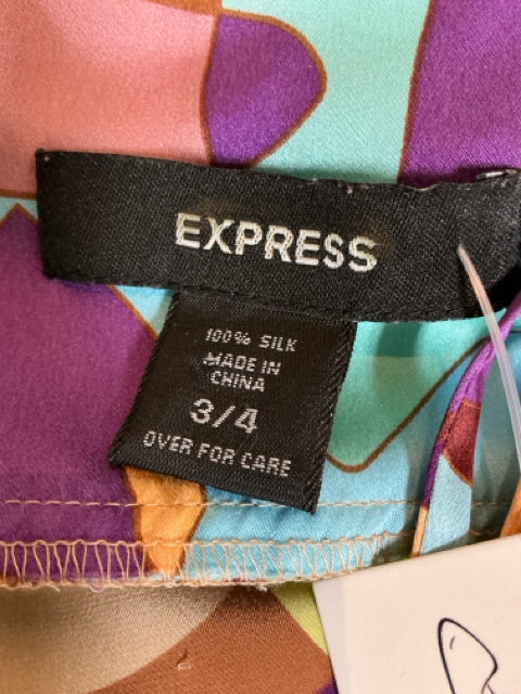 Close-up of Express dress label showing 100% silk, made in China, size 3/4. Confirms authenticity and fabric quality of this vintage slip dress.