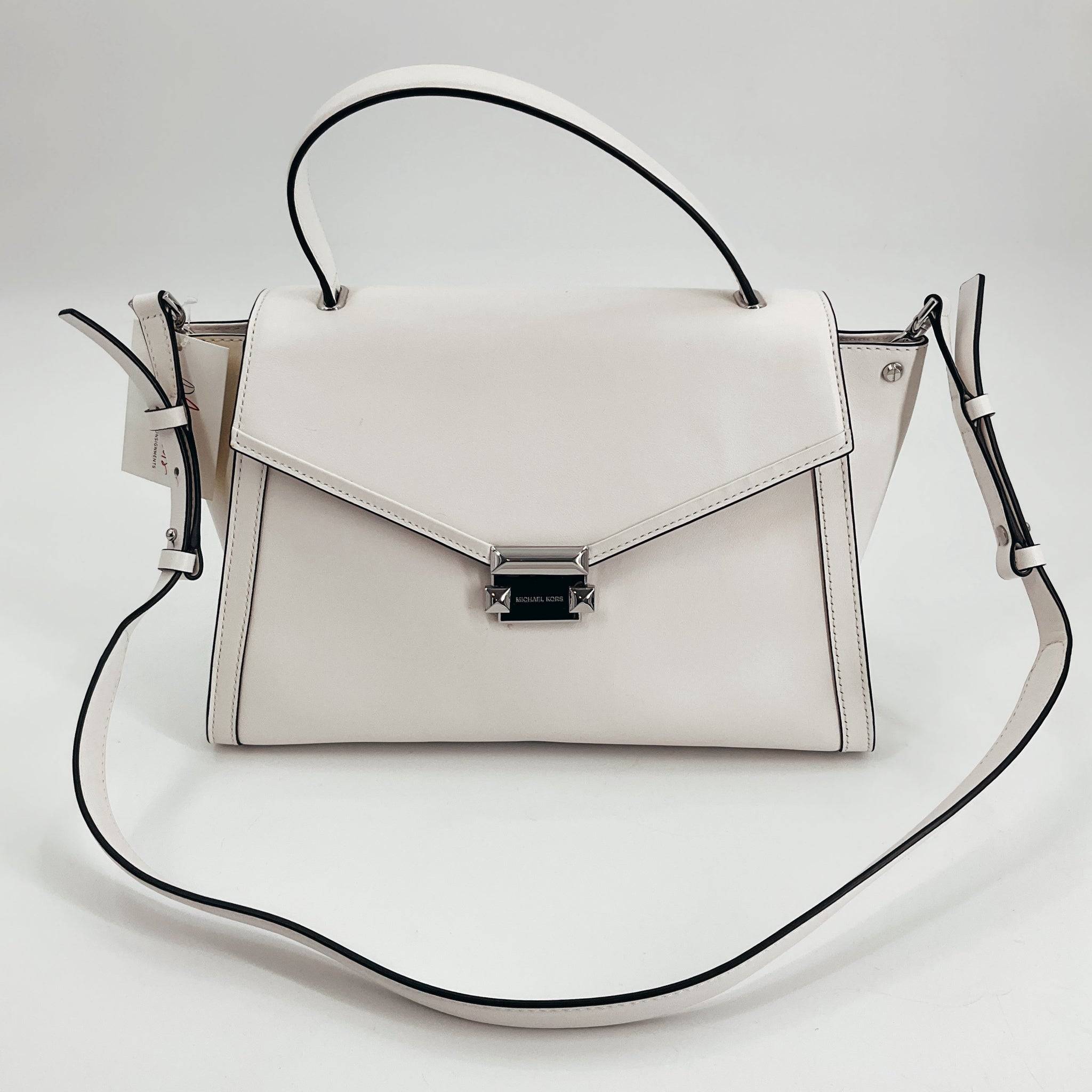 Michael Kors White Solid Pre-Owned Purse with structured flap design and adjustable crossbody strap, available at Margaret’s Fine Consignment. Elegant and gently used handbag ideal for versatile styling.