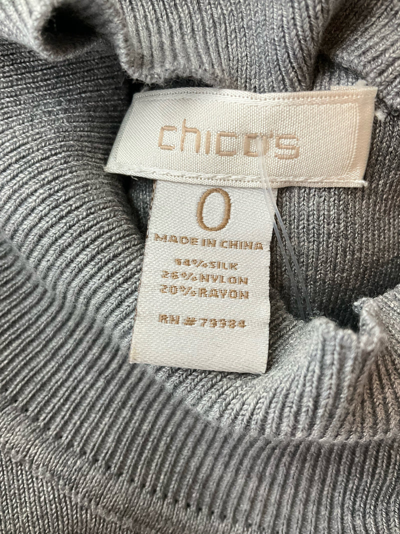 Fabric content tag of Chico's gray sleeveless top showing 52% silk, 28% nylon, and 20% rayon blend for a luxurious feel.