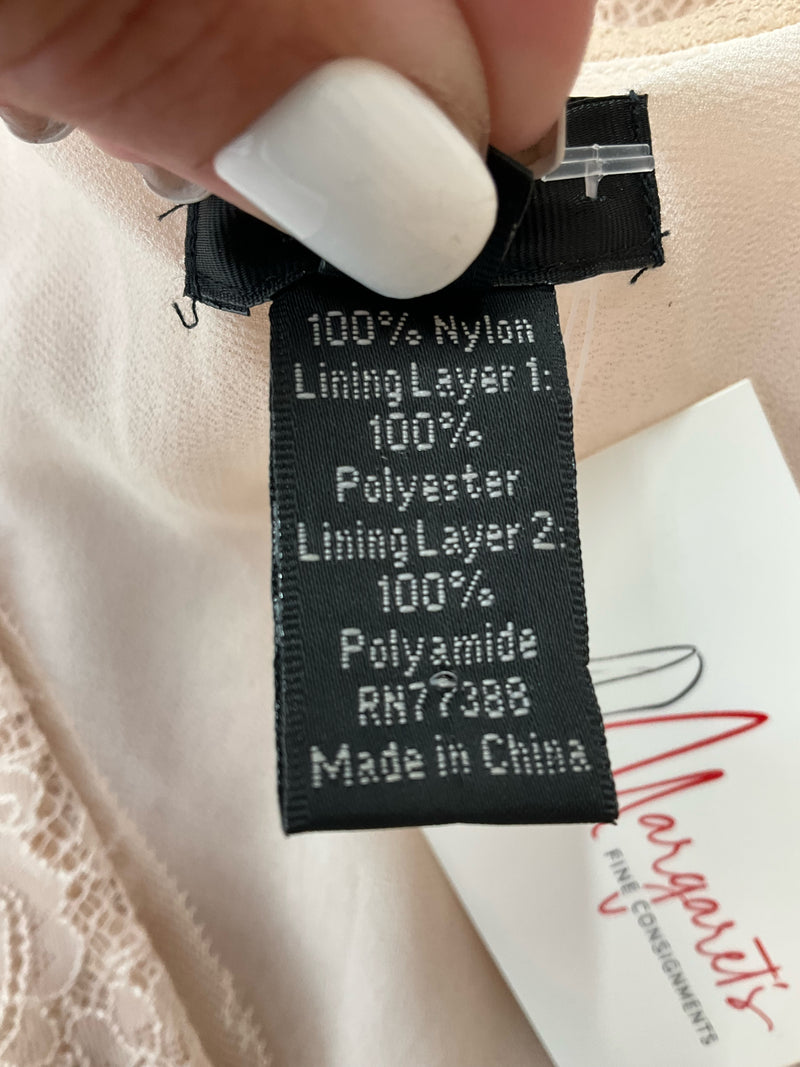 Fabric tag of J Crew Natural Lace Pre-Owned Ladies Top - Size 6 detailing material blend of nylon, polyester, and polyamide for product authenticity.