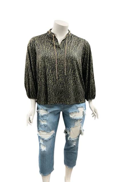 Pre-owned C Wonder Green Animal Print Casual Top Size 1X displayed on mannequin with ripped jeans at Margaret's Fine Consignments.