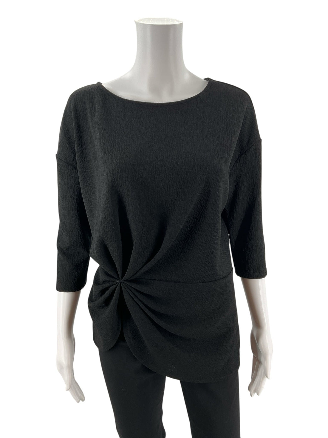 Vince Camuto black boat neck top with twist front, drop shoulder, and asymmetrical design, size small.