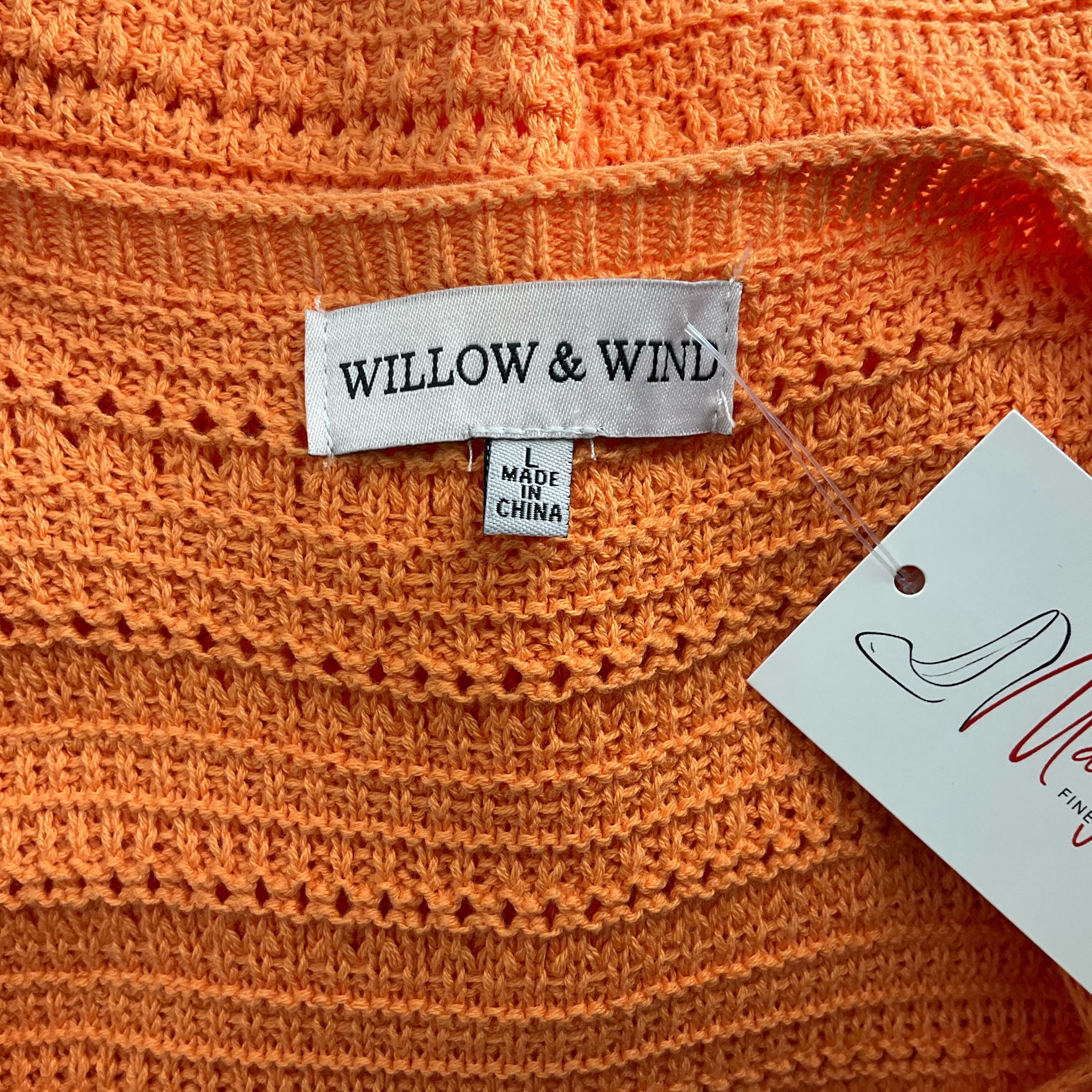 Close-up of Willow & Wind brand label on the Orange Knit Dress - Size Large, confirming authenticity and size.