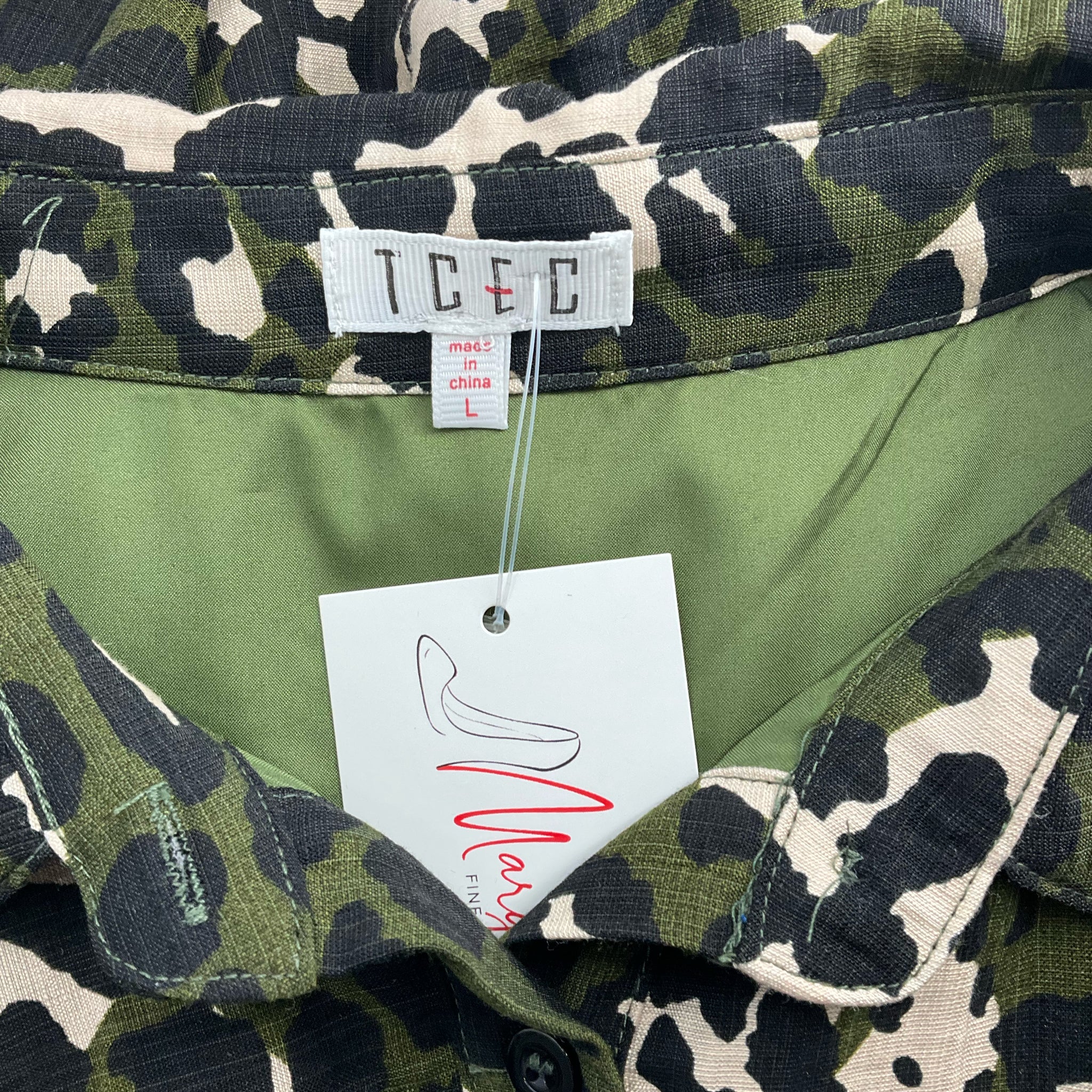 Close-up of Tcec brand label on Olive/Black Animal Print Dress - Size Large with visible tag and collar detail.