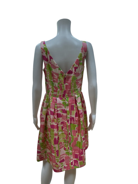 Back view of Kay Unger White/Green/Pink Print Pre-Owned Ladies Dress - Size 10 with deep V-back and pleated skirt, ideal for cocktail or wedding guest attire.