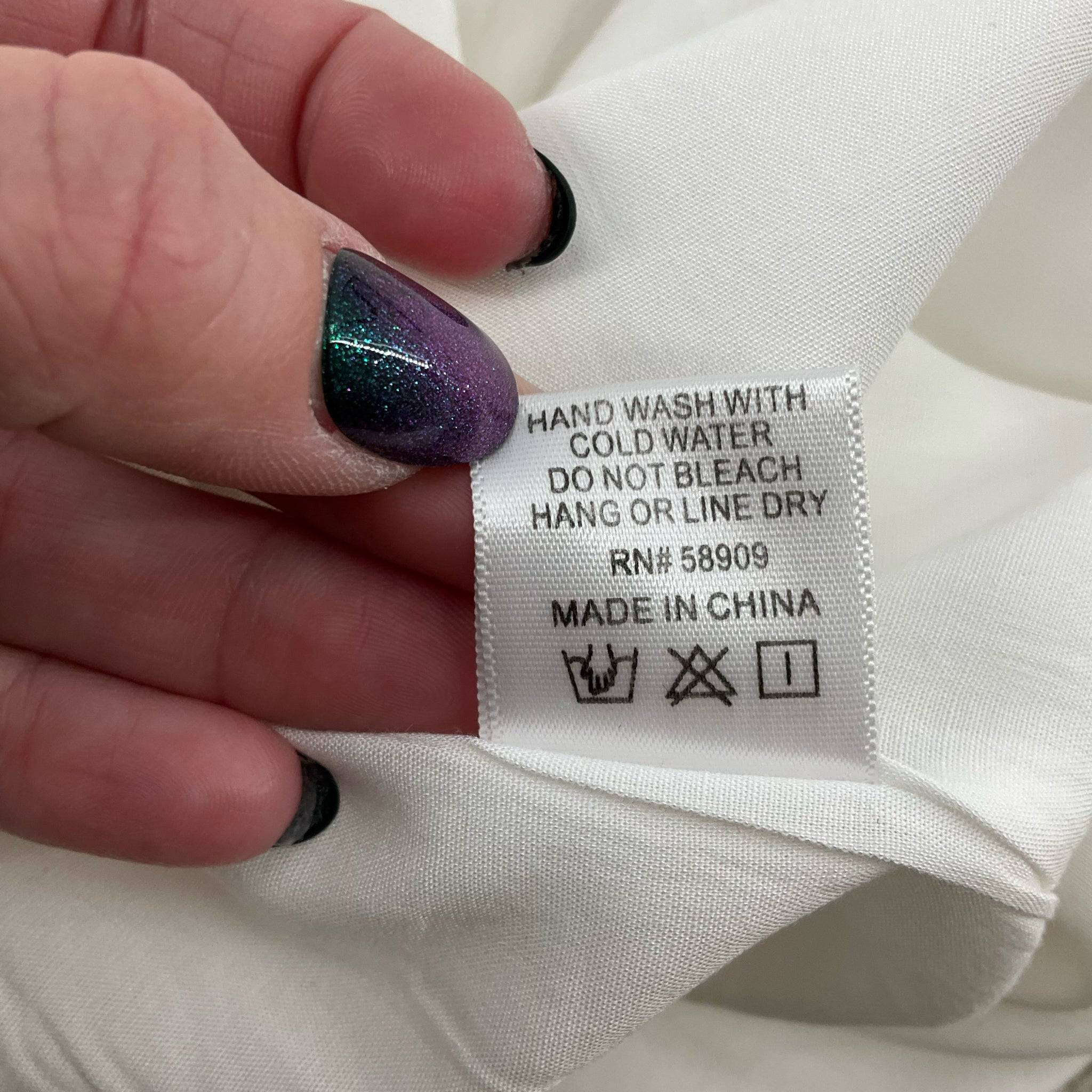 Care label of GB White Sleeveless Mini Dress Size Medium with washing instructions, made in China, suitable for delicate handling.