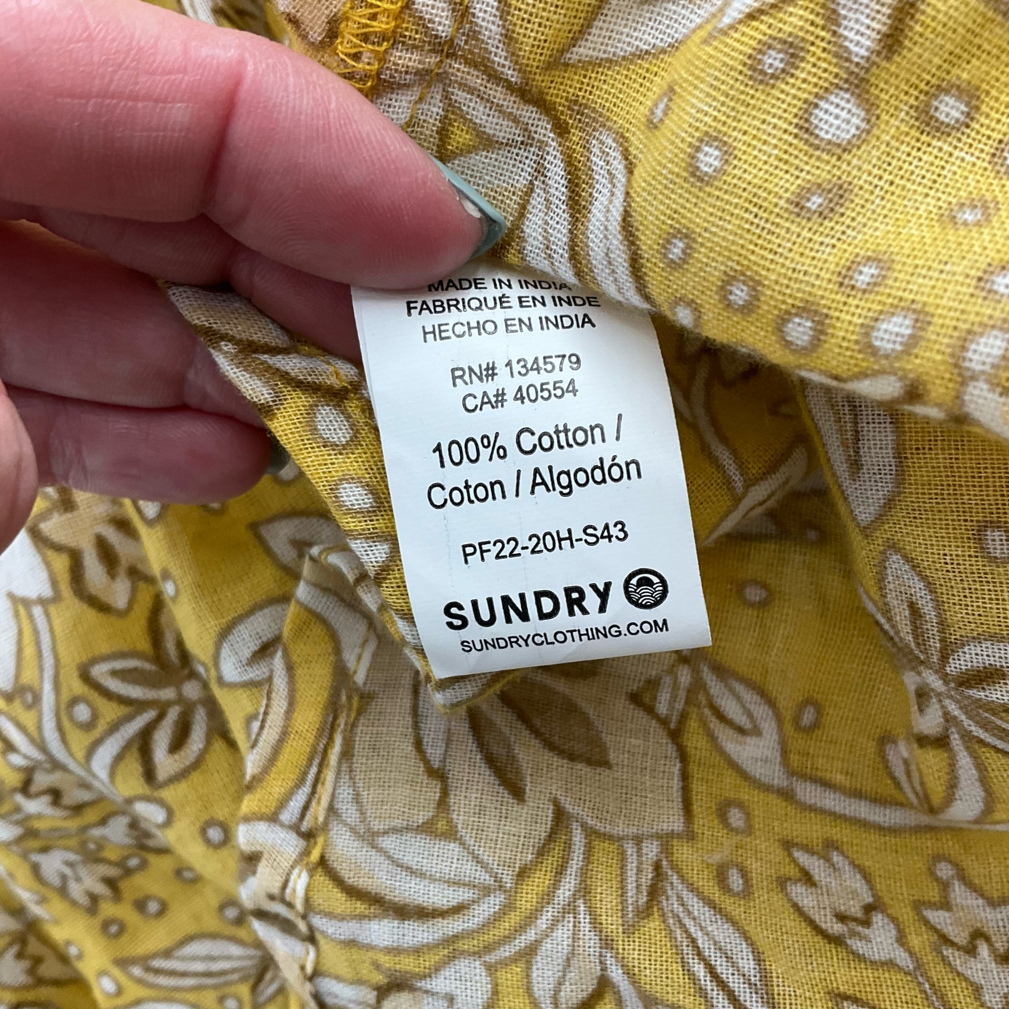 Fabric content tag of Sundry Yellow/Tan Floral Dress - Size 4 showing 100% cotton material, made in India, ideal for breathable wear.