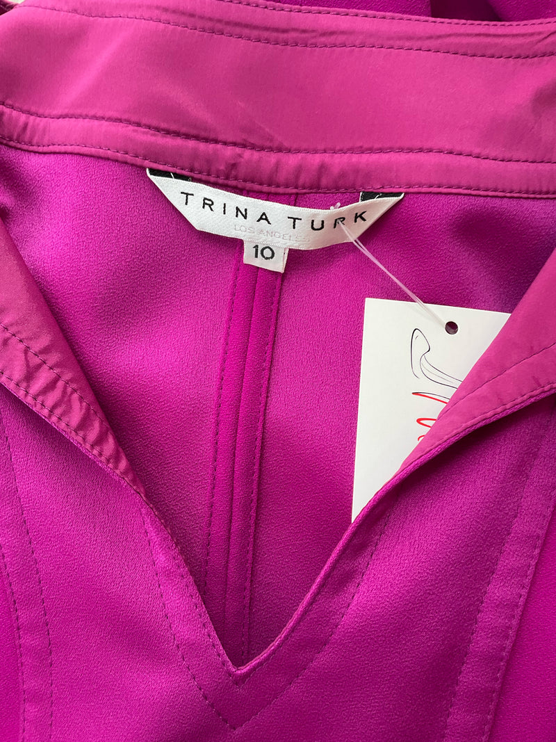 Close-up of Trina Turk label and size tag on Fuschia Solid Pre-Owned Ladies Dress Size 10, confirming brand authenticity and size.