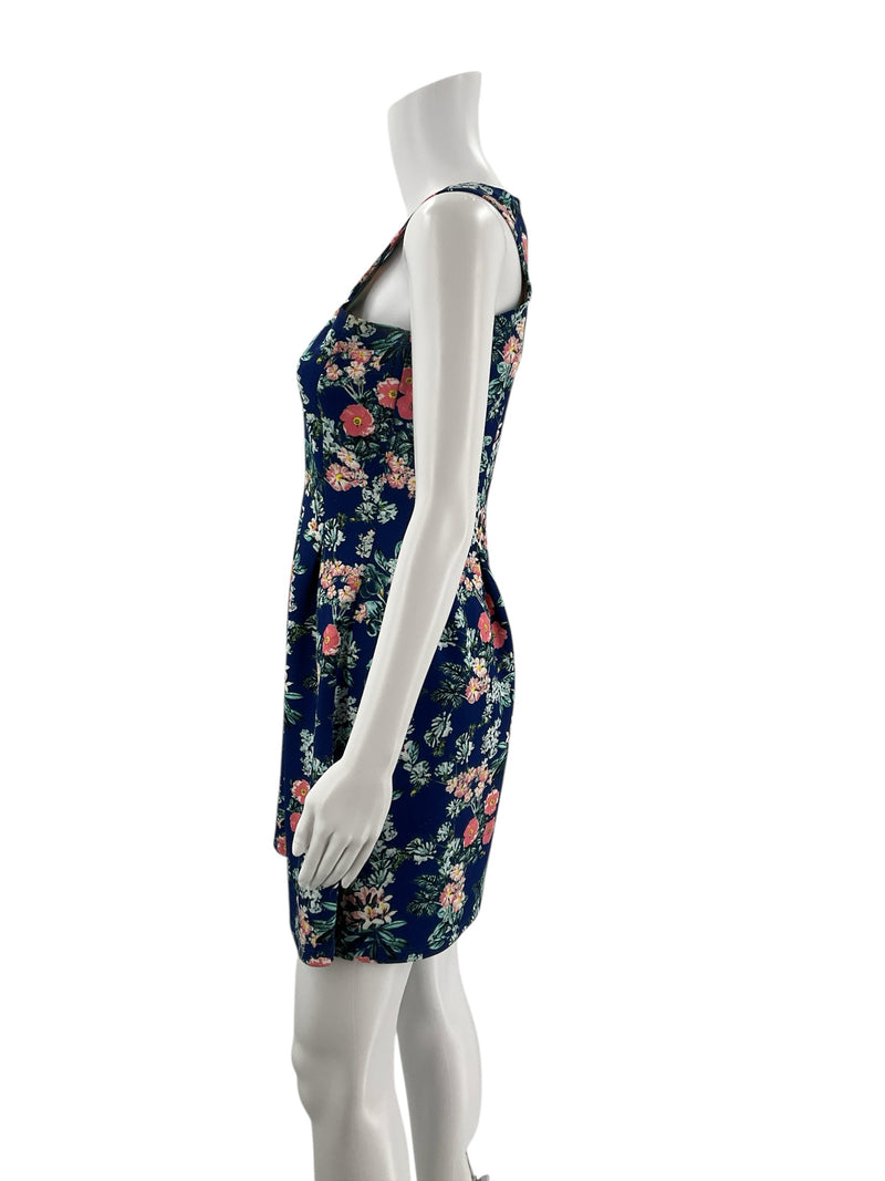 Side profile of Pink Rose sleeveless skater dress in navy with pink and green floral print, highlighting flared hem and fitted bodice.