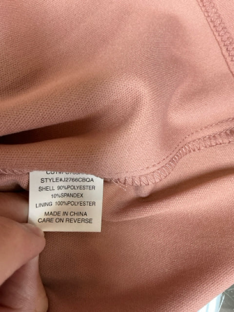 Close-up of fabric tag on C. Wonder mauve lace dress showing style number J2766CB0AQ and material composition of polyester and spandex.
