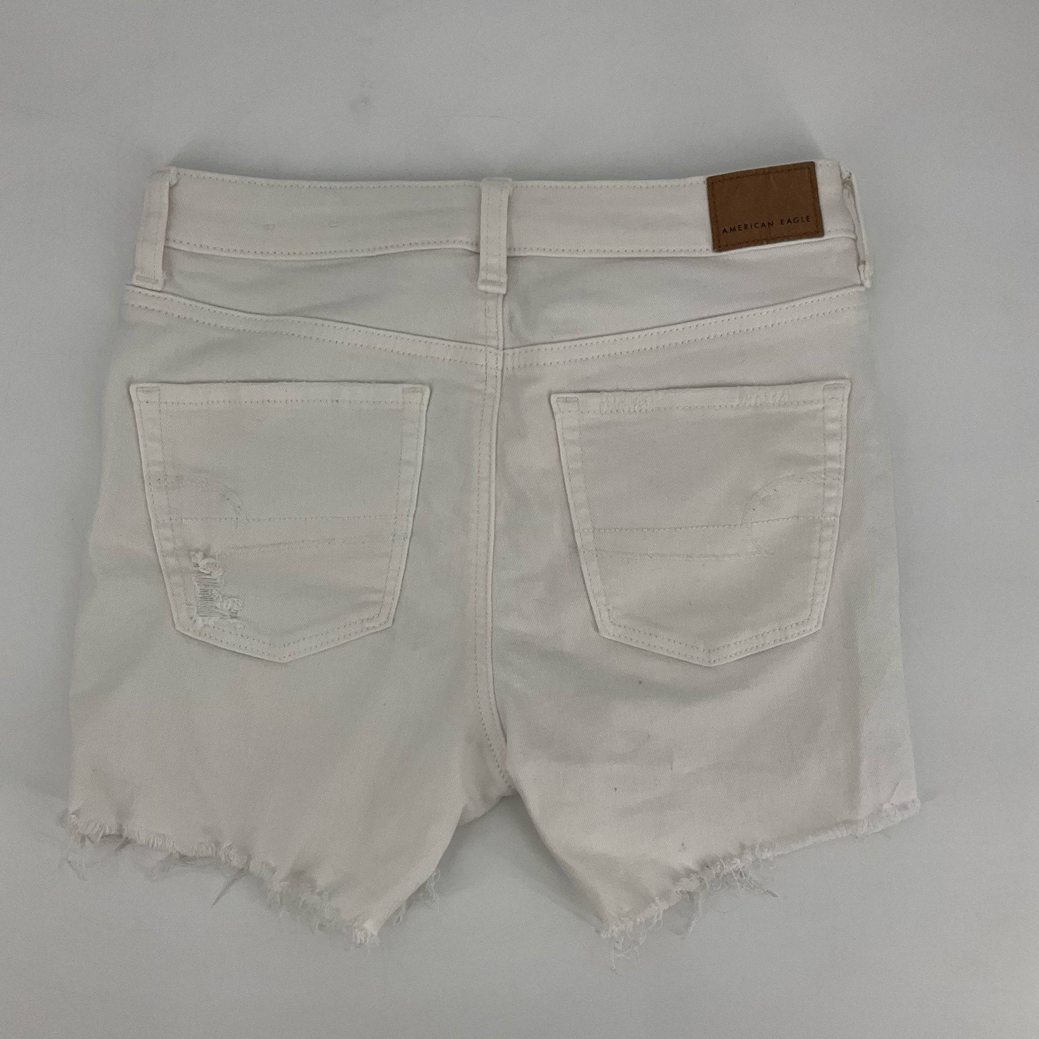 Back view of american eagle Size 4 White ripped Shorts featuring two rear pockets and a leather brand patch on the waistband.