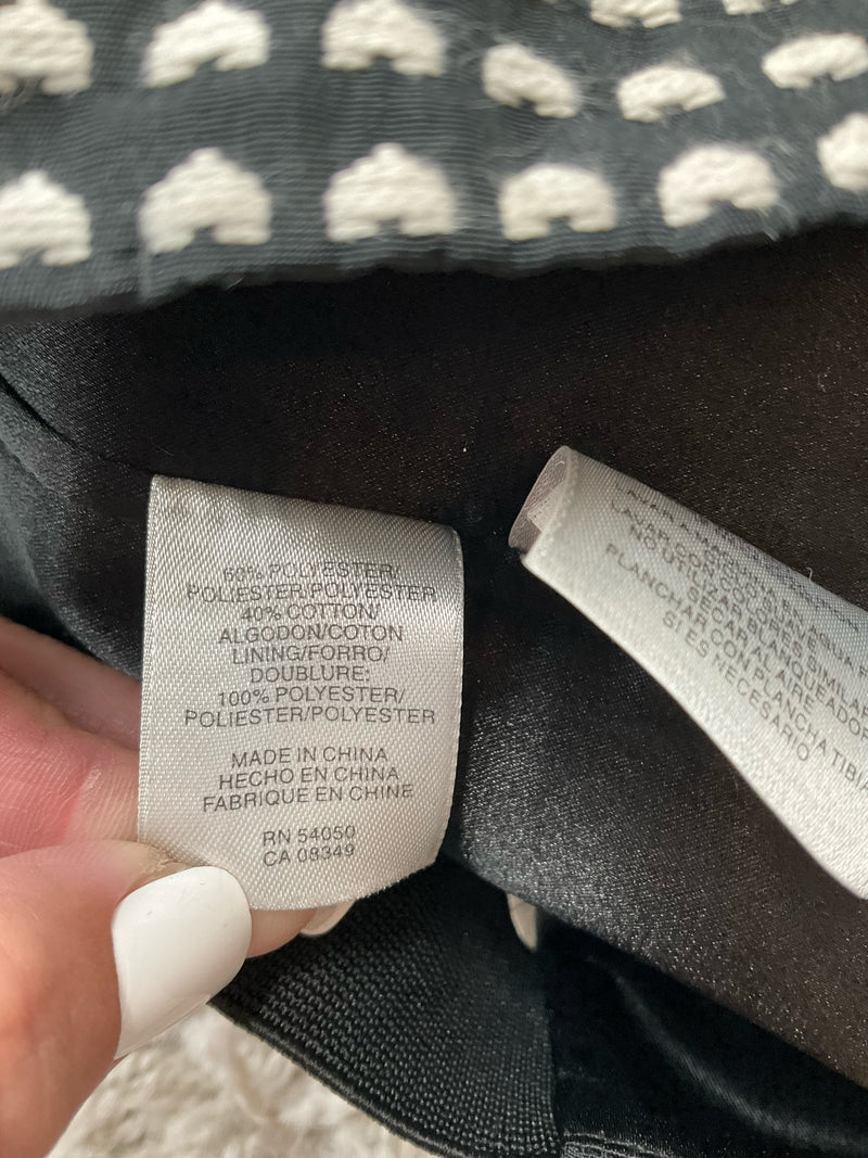 Fabric content tag of Rachel Roy mini dress showing 100% cotton shell and 100% polyester lining, made in China, size 10.